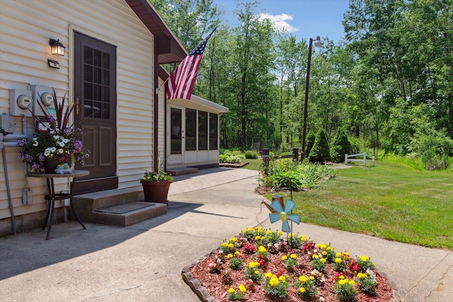 10343 N Walnut Ave, Bitely, MI 49309 - view of grassy yard with a sunroom