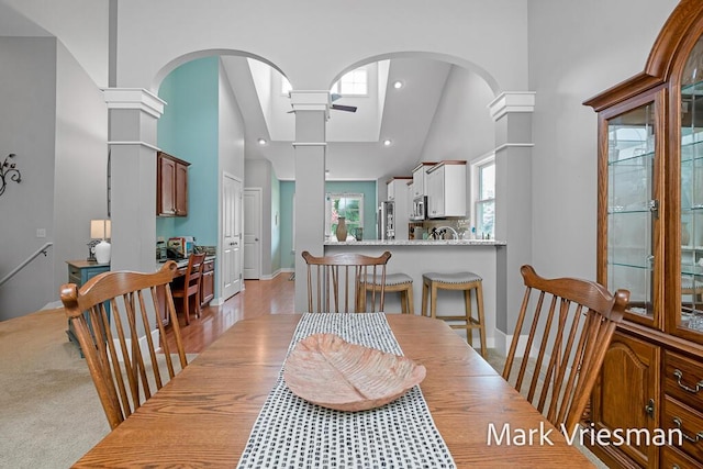 13497 Hidden Creek Ct, Grand Haven, MI 49417 - dining space featuring ceiling fan, high vaulted ceiling, arched walkways, and recessed lighting