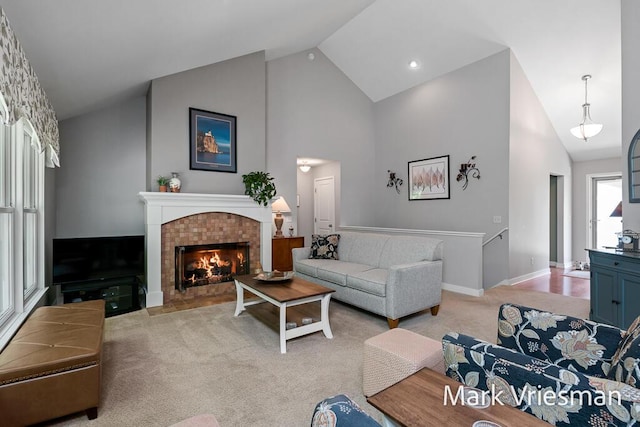 13497 Hidden Creek Ct, Grand Haven, MI 49417 - living room featuring light colored carpet, high vaulted ceiling, and a fireplace