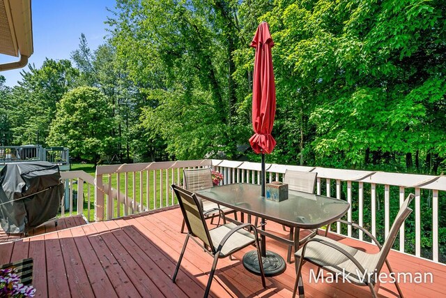 13497 Hidden Creek Ct, Grand Haven, MI 49417 - wooden terrace with outdoor dining area, a grill, and a lawn
