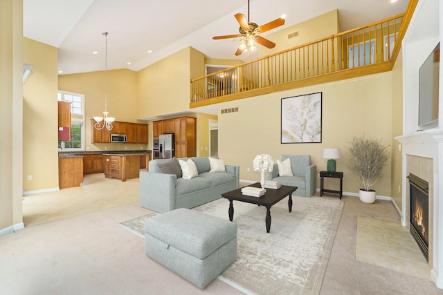 2032 Cameo Ct, Canton, MI 48187 - living room featuring light colored carpet, a fireplace, high vaulted ceiling, a chandelier, and a ceiling fan