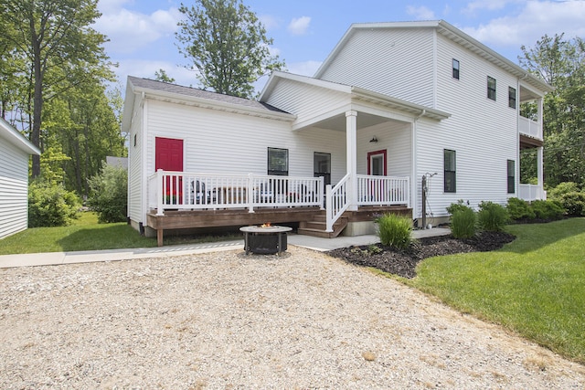 7285 Maple St, South Haven, MI 49090 - view of front facade featuring a front lawn, an outdoor fire pit, and a deck