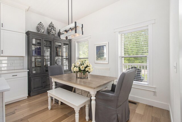 7285 Maple St, South Haven, MI 49090 - dining room with light wood-style flooring and baseboards