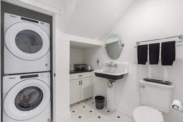7285 Maple St, South Haven, MI 49090 - bathroom with stacked washing machine and dryer and tile patterned flooring