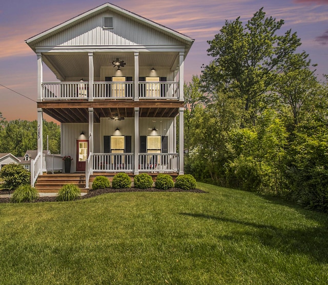 7285 Maple St, South Haven, MI 49090 - view of front of property featuring a front lawn, covered porch, a balcony, and a ceiling fan