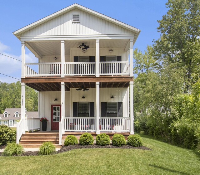 7285 Maple St, South Haven, MI 49090 - view of front facade featuring a ceiling fan, a balcony, covered porch, and a front lawn