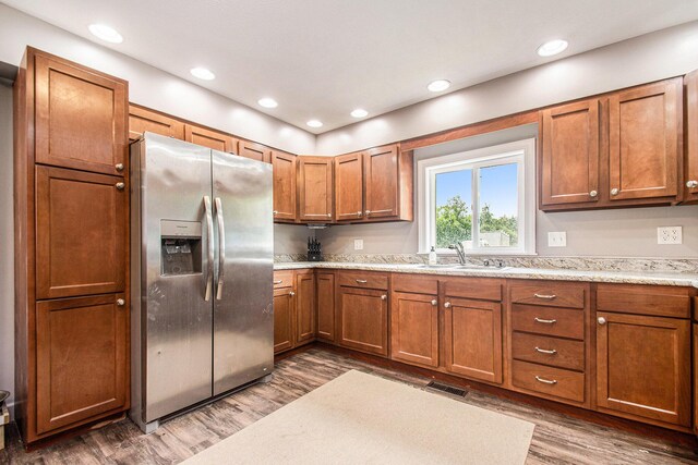 2813 Bond St, Niles, MI 49120 - kitchen with stainless steel refrigerator with ice dispenser, brown cabinetry, wood finished floors, and recessed lighting