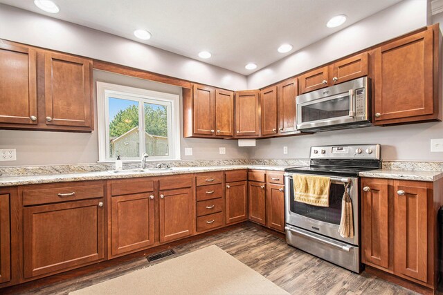 2813 Bond St, Niles, MI 49120 - kitchen featuring stainless steel appliances, brown cabinetry, dark wood finished floors, and recessed lighting