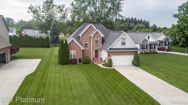 3167 Blackheath Ct, Port Huron, MI 48060 - view of front of property with concrete driveway, brick siding, a garage, and a front lawn
