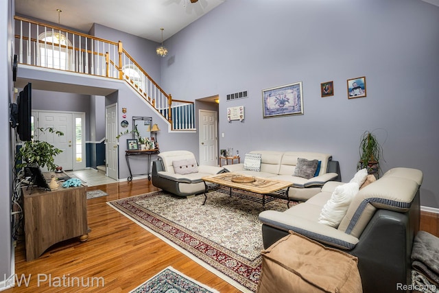 3167 Blackheath Ct, Port Huron, MI 48060 - living room featuring wood finished floors, a high ceiling, stairs, and a ceiling fan