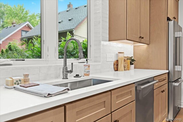 624 S Vermont Ave, Royal Oak, MI 48067 - kitchen with appliances with stainless steel finishes, backsplash, and light countertops