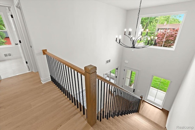 624 S Vermont Ave, Royal Oak, MI 48067 - stairs featuring a chandelier, wood finished floors, and a high ceiling