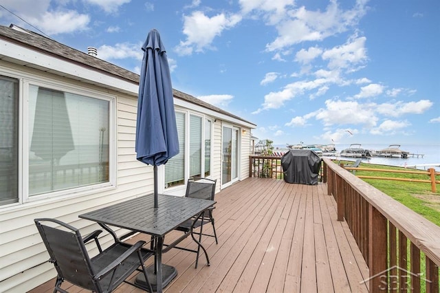 6276 W Houghton Lake Dr, Houghton Lake, MI 48629 - wooden deck with a water view, outdoor dining space, and area for grilling