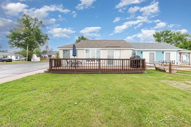 6276 W Houghton Lake Dr, Houghton Lake, MI 48629 - back of house with a yard and a wooden deck