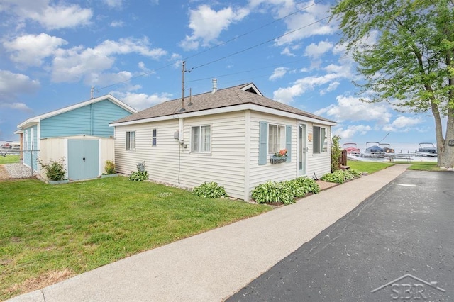 6276 W Houghton Lake Dr, Houghton Lake, MI 48629 - view of home's exterior with a storage unit and a yard