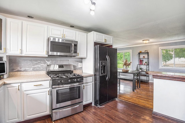 3463 Arthur Rd, Remus, MI 49340 - kitchen featuring stainless steel appliances, white cabinetry, light countertops, dark wood-type flooring, and backsplash