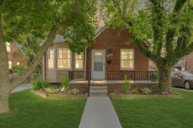 22406 Colony St, Saint Clair Shores, MI 48080 - view of front of home with a front lawn, brick siding, and a porch