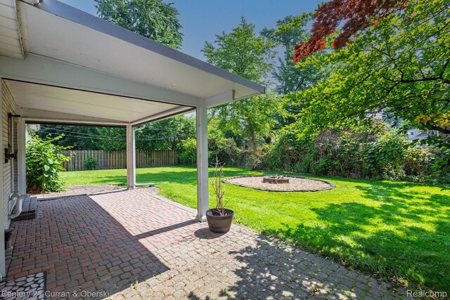 20740 Marter Rd, Grosse Pointe Woods, MI 48236 - fenced backyard with an outdoor fire pit and a patio area
