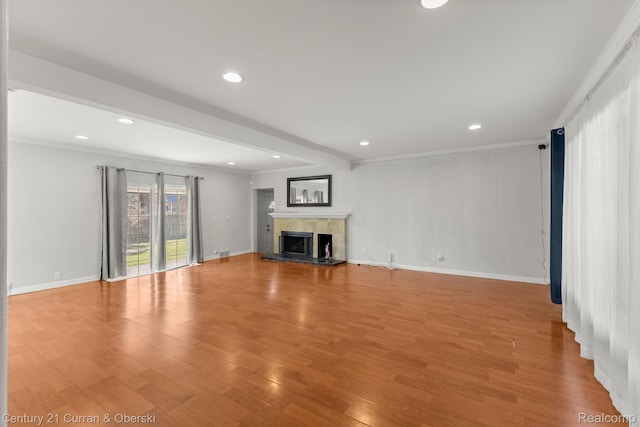 20740 Marter Rd, Grosse Pointe Woods, MI 48236 - unfurnished living room with recessed lighting, a fireplace with raised hearth, light wood finished floors, and crown molding