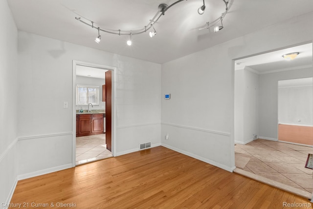 20740 Marter Rd, Grosse Pointe Woods, MI 48236 - spare room featuring light wood-style flooring and baseboards