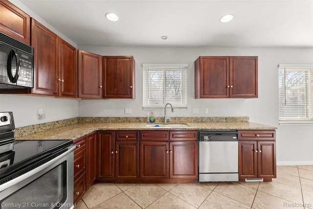 20740 Marter Rd, Grosse Pointe Woods, MI 48236 - kitchen with appliances with stainless steel finishes, healthy amount of natural light, light tile patterned floors, light stone counters, and recessed lighting