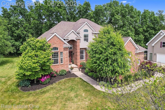 9806 Goldfinch Ct, Saline, MI 48176 - traditional-style house with a front yard and brick siding