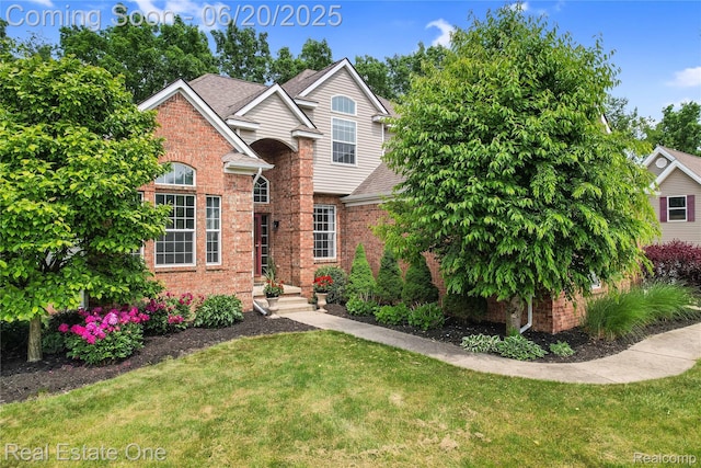9806 Goldfinch Ct, Saline, MI 48176 - traditional-style house featuring a front lawn, brick siding, and a shingled roof
