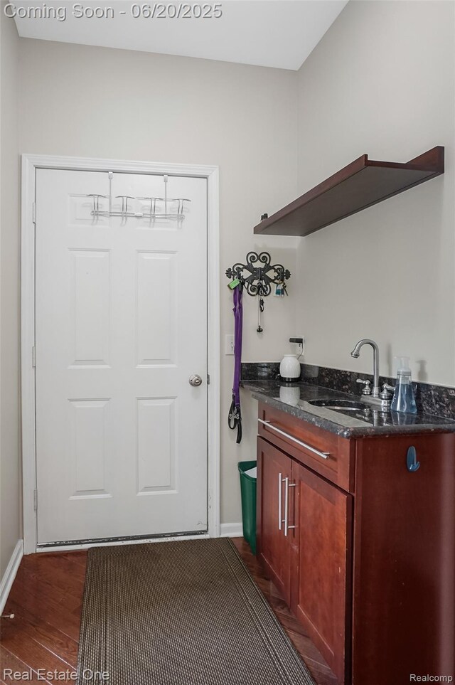 9806 Goldfinch Ct, Saline, MI 48176 - laundry room with a sink and dark wood-style flooring