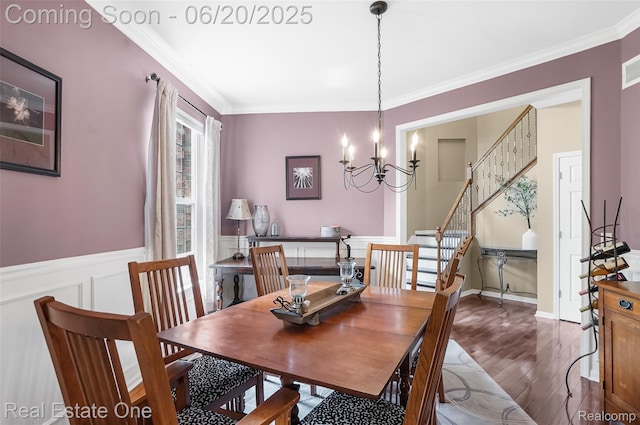 9806 Goldfinch Ct, Saline, MI 48176 - dining room featuring ornamental molding, wood finished floors, a chandelier, wainscoting, and stairs
