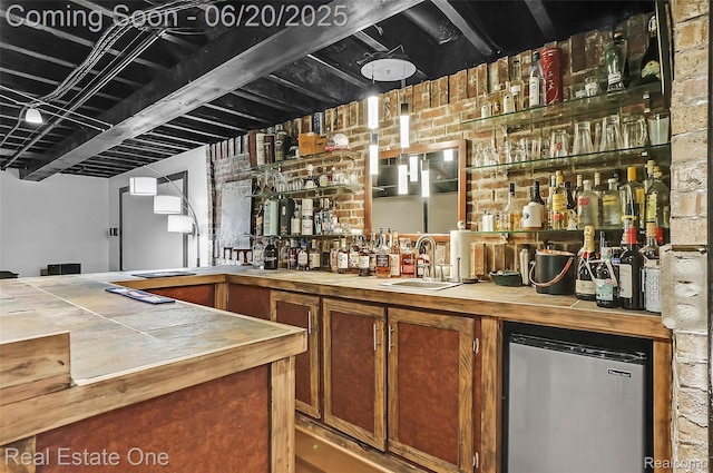 9806 Goldfinch Ct, Saline, MI 48176 - indoor wet bar featuring fridge and brick wall