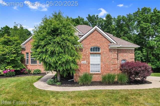 9806 Goldfinch Ct, Saline, MI 48176 - view of front facade featuring a front yard and brick siding