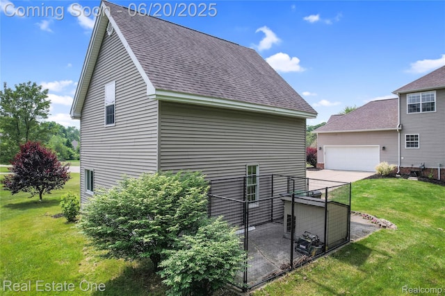 9806 Goldfinch Ct, Saline, MI 48176 - view of side of home with a lawn, a shingled roof, and an attached garage
