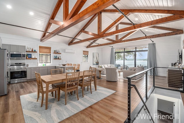 10296 S Lakeside Ridge Rd, Baldwin, MI 49304 - dining area featuring an AC wall unit, a water view, light wood finished floors, and recessed lighting
