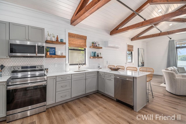10296 S Lakeside Ridge Rd, Baldwin, MI 49304 - kitchen with appliances with stainless steel finishes, gray cabinetry, light wood-style flooring, open shelves, and wood ceiling