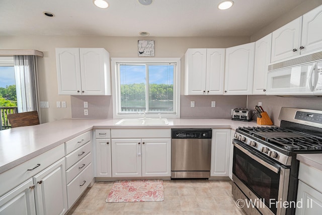 10296 S Lakeside Ridge Rd, Baldwin, MI 49304 - kitchen with appliances with stainless steel finishes, healthy amount of natural light, recessed lighting, and white cabinets