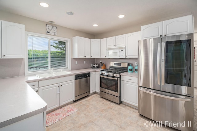 10296 S Lakeside Ridge Rd, Baldwin, MI 49304 - kitchen featuring stainless steel appliances, white cabinets, recessed lighting, and light countertops