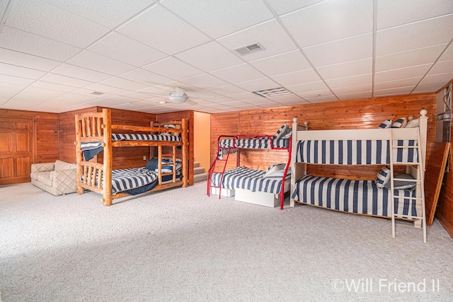 10296 S Lakeside Ridge Rd, Baldwin, MI 49304 - carpeted bedroom featuring wooden walls and a drop ceiling