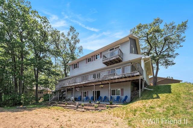 10296 S Lakeside Ridge Rd, Baldwin, MI 49304 - back of property with a balcony, a patio, a deck, a yard, and stairs