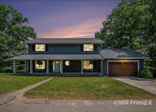 10296 S Lakeside Ridge Rd, Baldwin, MI 49304 - view of front of house with a garage, concrete driveway, covered porch, a yard, and roof with shingles