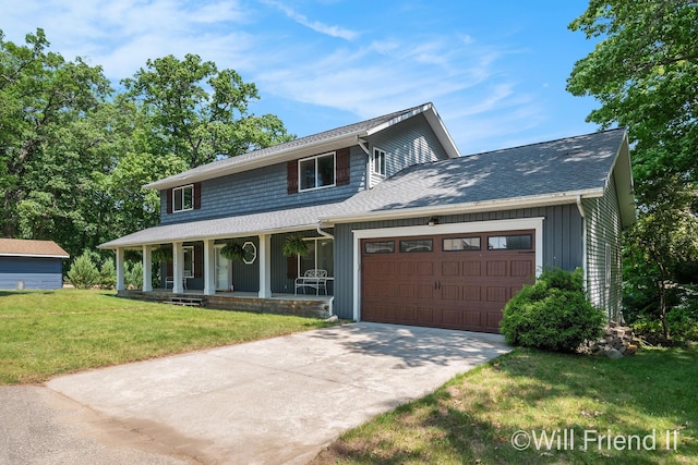 10296 S Lakeside Ridge Rd, Baldwin, MI 49304 - view of front facade featuring covered porch, a garage, a front lawn, driveway, and a shingled roof
