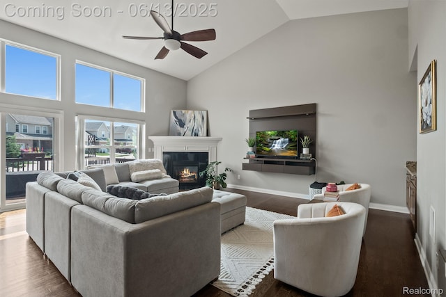 4376 Bennett Park Cir, Troy, MI 48085 - living room with a glass covered fireplace, high vaulted ceiling, ceiling fan, and dark wood-style flooring