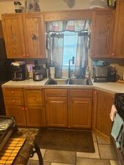 2928 Austin St, Muskegon, MI 49444 - kitchen with stove, light countertops, and brown cabinets