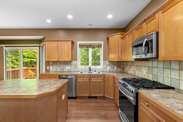 1995 Shining Tree Dr NE, Belmont, MI 49306 - kitchen with stainless steel appliances, wood finished floors, light countertops, recessed lighting, and tasteful backsplash