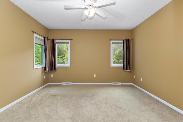 1995 Shining Tree Dr NE, Belmont, MI 49306 - spare room featuring carpet flooring, healthy amount of natural light, and a ceiling fan