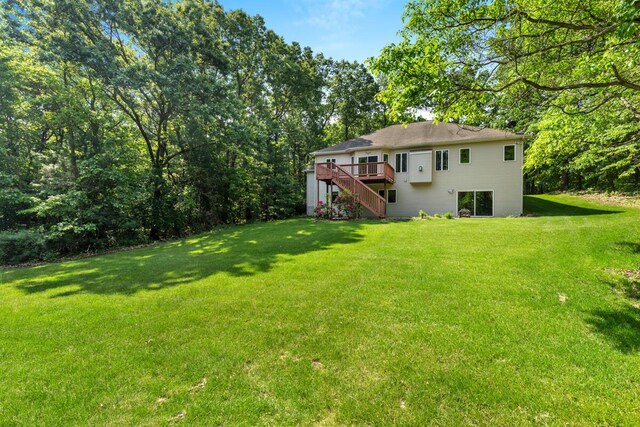 1995 Shining Tree Dr NE, Belmont, MI 49306 - view of grassy yard with stairs and a deck