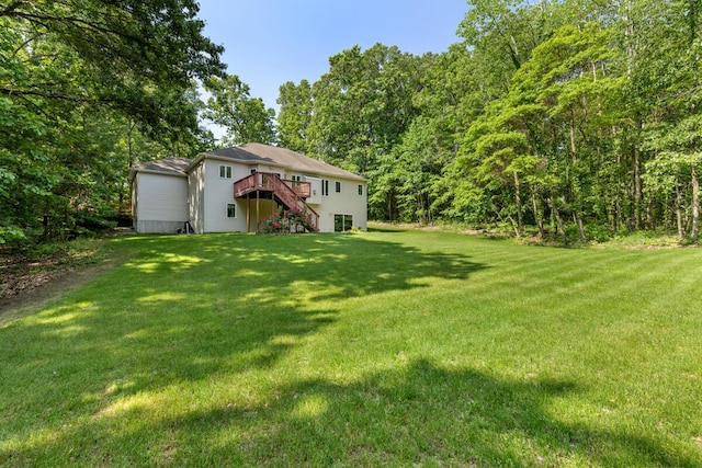 1995 Shining Tree Dr NE, Belmont, MI 49306 - view of grassy yard with stairway and a wooden deck