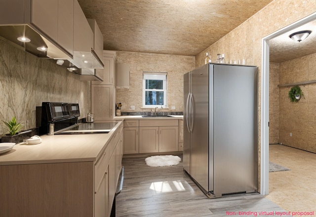 8114 E 72nd St # 2, Newaygo, MI 49337 - kitchen featuring freestanding refrigerator, stove, light countertops, ventilation hood, and light wood finished floors