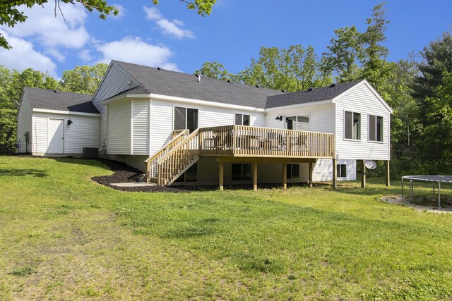 8114 E 72nd St # 2, Newaygo, MI 49337 - rear view of house featuring a trampoline, a wooden deck, stairway, and a lawn