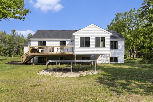 8114 E 72nd St # 2, Newaygo, MI 49337 - rear view of property with a wooden deck, stairway, roof with shingles, a lawn, and a trampoline