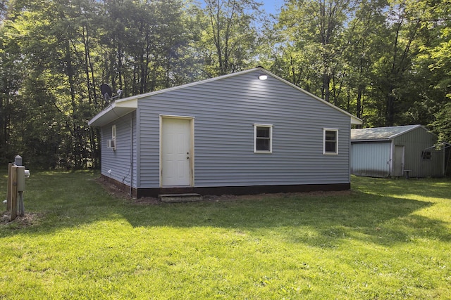 8114 E 72nd St # 2, Newaygo, MI 49337 - view of home's exterior with a lawn and an outdoor structure